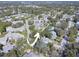 Aerial view of the community with mature trees and lush landscaping at 428 Windrush Bay Dr, Tarpon Springs, FL 34689
