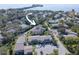 Aerial view showcasing the layout of a condo community with parking and access to the water at 428 Windrush Bay Dr, Tarpon Springs, FL 34689