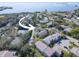 Aerial view of a residential neighborhood near the water, surrounded by lush greenery and trees at 428 Windrush Bay Dr, Tarpon Springs, FL 34689
