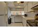 Classic kitchen with white cabinetry, white countertops, and tiled flooring at 428 Windrush Bay Dr, Tarpon Springs, FL 34689