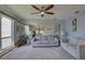 Spacious living room with a large mirror, comfortable seating, and natural light from the adjacent lanai at 428 Windrush Bay Dr, Tarpon Springs, FL 34689