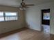 Cozy bedroom with wood floors, ceiling fan, and windows, offering a comfortable living space at 480 82Nd Ave, St Pete Beach, FL 33706