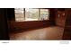 Wood-paneled living room featuring large windows, tile flooring, and natural light at 480 82Nd Ave, St Pete Beach, FL 33706