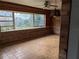 Wood-paneled living room with large windows, offering natural light and views at 480 82Nd Ave, St Pete Beach, FL 33706