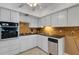 Bright kitchen with white cabinets, granite counters, and stainless steel appliances at 2298 Netherlands Dr # 4, Clearwater, FL 33763