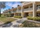 Exterior view of condo building with lush landscaping and walkway at 2298 Netherlands Dr # 4, Clearwater, FL 33763