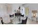 Small dining area with glass table and four chairs at 2298 Netherlands Dr # 4, Clearwater, FL 33763