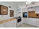 Kitchen boasts white cabinets, granite countertops, and built-in microwave at 2298 Netherlands Dr # 4, Clearwater, FL 33763
