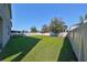 Large grassy backyard with a privacy fence at 11115 Spring Point Cir, Riverview, FL 33579