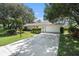 Front view of a single story house with a white garage at 7328 Sugarbush Dr, Spring Hill, FL 34606