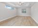 Bright bedroom with wood-look floors and a ceiling fan at 4000 Southern Valley Loop, Brooksville, FL 34601