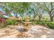 Serene courtyard with a tiered fountain and benches at 4028 Davit Dr # 4028, New Port Richey, FL 34652
