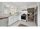 Kitchen with granite countertop, white cabinets, and stainless steel appliances at 4028 Davit Dr # 4028, New Port Richey, FL 34652