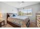 Bright bedroom with a queen bed and wood dresser at 4028 Davit Dr # 4028, New Port Richey, FL 34652