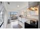 Kitchen with granite countertops, white cabinets, and access to a balcony at 4028 Davit Dr # 4028, New Port Richey, FL 34652