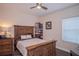 Cozy guest bedroom with a wooden bed frame and window at 9226 Highland Ridge Way, Tampa, FL 33647