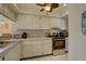 Bright kitchen features white cabinets, stainless steel appliances, and patterned backsplash at 428 Windrush Bay Dr, Tarpon Springs, FL 34689