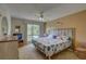 Main bedroom with king-size bed, ceiling fan, and beach themed decor at 428 Windrush Bay Dr, Tarpon Springs, FL 34689
