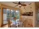 Dining area with glass table, four chairs, and kitchen bar at 428 Windrush Bay Dr, Tarpon Springs, FL 34689