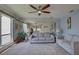 Spacious living room with gray sofas, large mirror, and ample natural light at 428 Windrush Bay Dr, Tarpon Springs, FL 34689