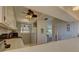 Kitchen with white cabinets, stainless steel appliances, and view into living room at 428 Windrush Bay Dr, Tarpon Springs, FL 34689