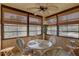 Sunroom with glass top table, four chairs, and ample natural light at 428 Windrush Bay Dr, Tarpon Springs, FL 34689