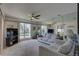 Living room features gray sofas, large mirror, and view of the outdoors at 428 Windrush Bay Dr, Tarpon Springs, FL 34689