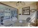 Bright sunroom with glass top table, four chairs, and view of living room at 428 Windrush Bay Dr, Tarpon Springs, FL 34689