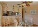 Bright dining area with glass table, four chairs, and kitchen bar at 428 Windrush Bay Dr, Tarpon Springs, FL 34689