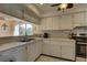 Kitchen with white cabinets, double sink, and appliances at 428 Windrush Bay Dr, Tarpon Springs, FL 34689