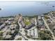 Aerial view of waterfront community with numerous buildings, parking, and a small pond at 428 Windrush Bay Dr, Tarpon Springs, FL 34689