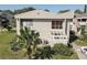 Tan condo building with a patio and palm trees in front at 428 Windrush Bay Dr, Tarpon Springs, FL 34689