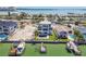 Expansive aerial perspective of a luxurious waterfront property, featuring a modern home and boat docks at 2832 W Vina Del Mar Blvd, St Pete Beach, FL 33706