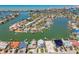 Wide aerial shot capturing a community with waterfront homes, canals, and lush landscaping on a sunny day at 2832 W Vina Del Mar Blvd, St Pete Beach, FL 33706