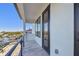 Private balcony featuring sleek railings and a glimpse of the waterfront, creating a tranquil outdoor retreat at 2832 W Vina Del Mar Blvd, St Pete Beach, FL 33706