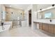 Modern bathroom with soaking tub, double shower, and long vanity with modern fixtures at 2832 W Vina Del Mar Blvd, St Pete Beach, FL 33706