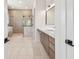 Modern bathroom with double shower, soaking tub, and long vanity with double sinks at 2832 W Vina Del Mar Blvd, St Pete Beach, FL 33706