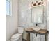 Stylish powder room with a stone vessel sink on wood counter and decorative tile wall at 2832 W Vina Del Mar Blvd, St Pete Beach, FL 33706