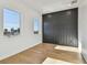 Modern bedroom with wood floors, neutral walls, and a unique black accent wall at 2832 W Vina Del Mar Blvd, St Pete Beach, FL 33706