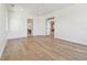 Bright bedroom with hardwood floors and white trim, showing a view through the doors at 2832 W Vina Del Mar Blvd, St Pete Beach, FL 33706