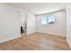 Bright, spacious bedroom features pristine hardwood floors, neutral decor, a bathroom and a window with neighborhood view at 2832 W Vina Del Mar Blvd, St Pete Beach, FL 33706
