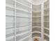 Spacious walk-in closet featuring custom shelving and ample storage space at 2832 W Vina Del Mar Blvd, St Pete Beach, FL 33706