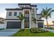 Stunning, modern home with a two-car garage and beautiful landscaping at 2832 W Vina Del Mar Blvd, St Pete Beach, FL 33706