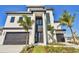 Stunning modern home with a sleek black-and-white design and lush landscaping at 2832 W Vina Del Mar Blvd, St Pete Beach, FL 33706
