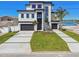 Modern home with well-manicured landscaping and concrete driveway at 2832 W Vina Del Mar Blvd, St Pete Beach, FL 33706