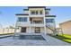 Back view of modern home featuring a pool, balconies, and outdoor staircase at 2832 W Vina Del Mar Blvd, St Pete Beach, FL 33706