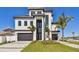 Stunning modern home with a two-car garage, manicured lawn, and striking architectural details at 2832 W Vina Del Mar Blvd, St Pete Beach, FL 33706