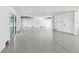 Large garage with epoxy flooring, recessed lighting, and multiple access points offers versatile space at 2832 W Vina Del Mar Blvd, St Pete Beach, FL 33706