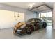 Modern garage featuring a black Porsche with red brake calipers parked inside, offering a stylish and secure space at 2832 W Vina Del Mar Blvd, St Pete Beach, FL 33706