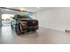 Spacious garage showcasing a black Cadillac Escalade, offering ample parking and storage space for luxury vehicles at 2832 W Vina Del Mar Blvd, St Pete Beach, FL 33706